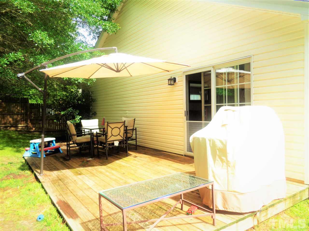 5304 Graymar Court Raleigh, NC 27616 - Photo 19 of 25 a view of a patio with table and chairs under an umbrella