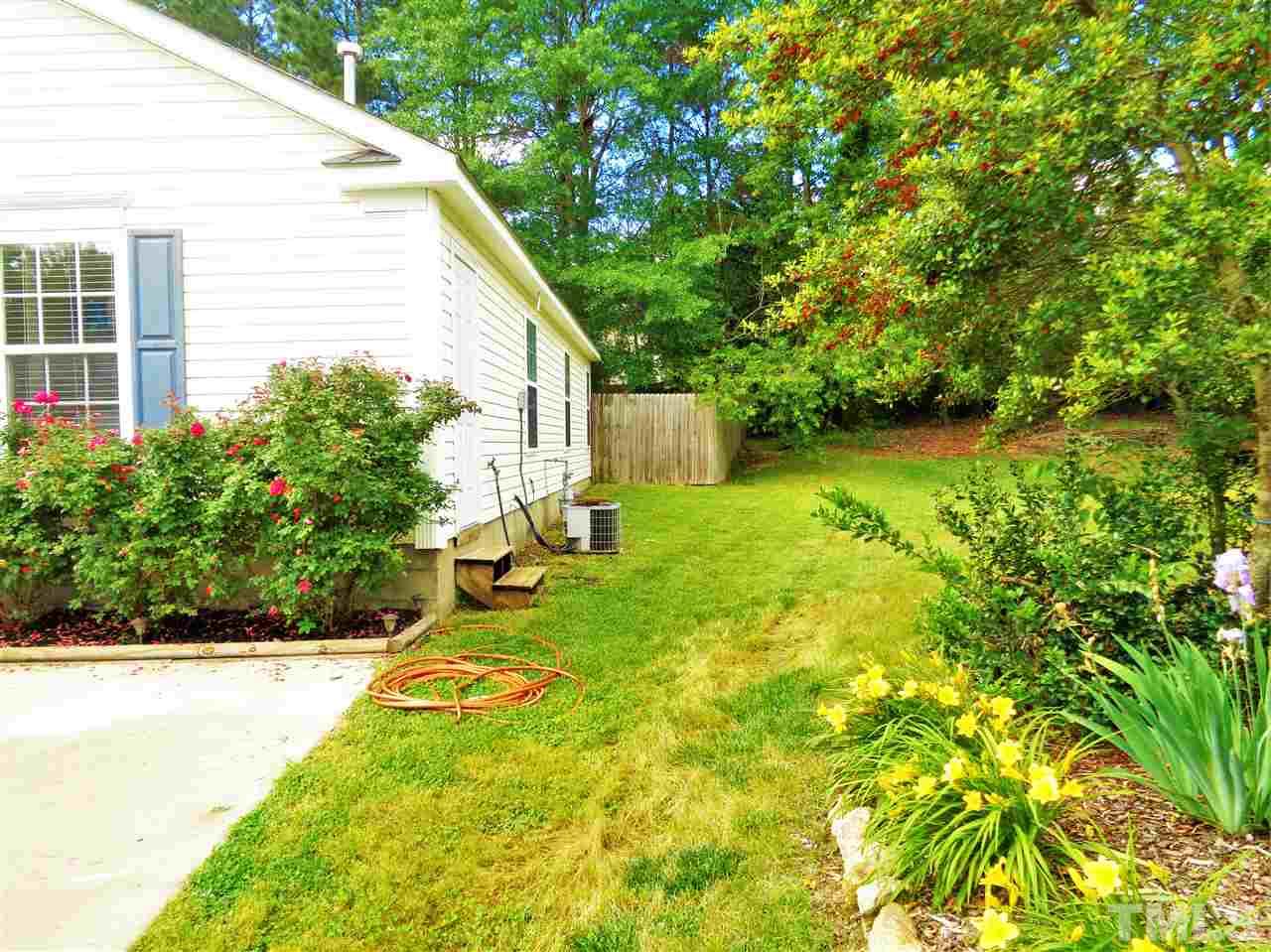 5304 Graymar Court Raleigh, NC 27616 - Photo 24 of 25 a view of a backyard with plants and large trees