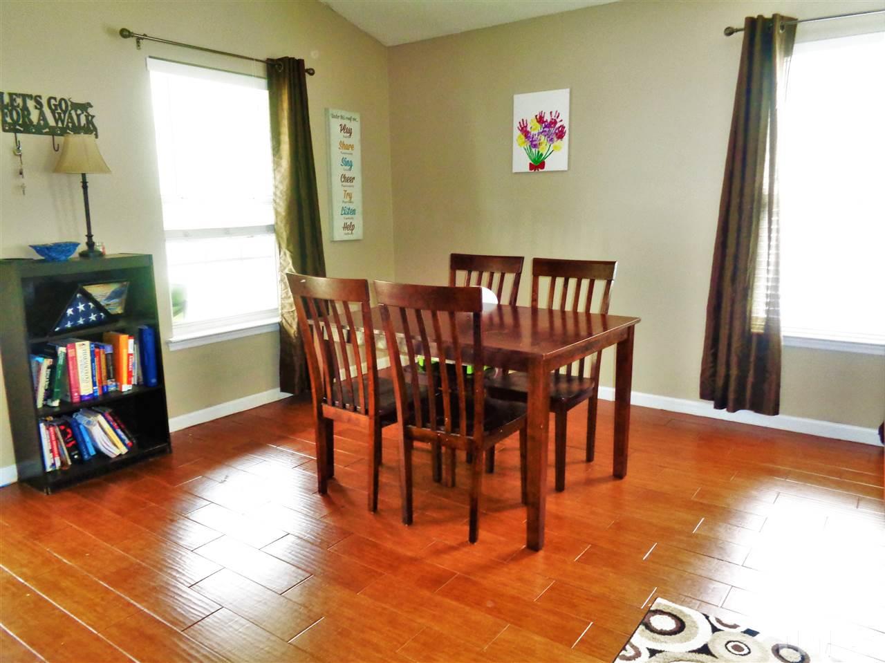 5304 Graymar Court Raleigh, NC 27616 - Photo 4 of 25 a view of a dining room with furniture and a book shelf