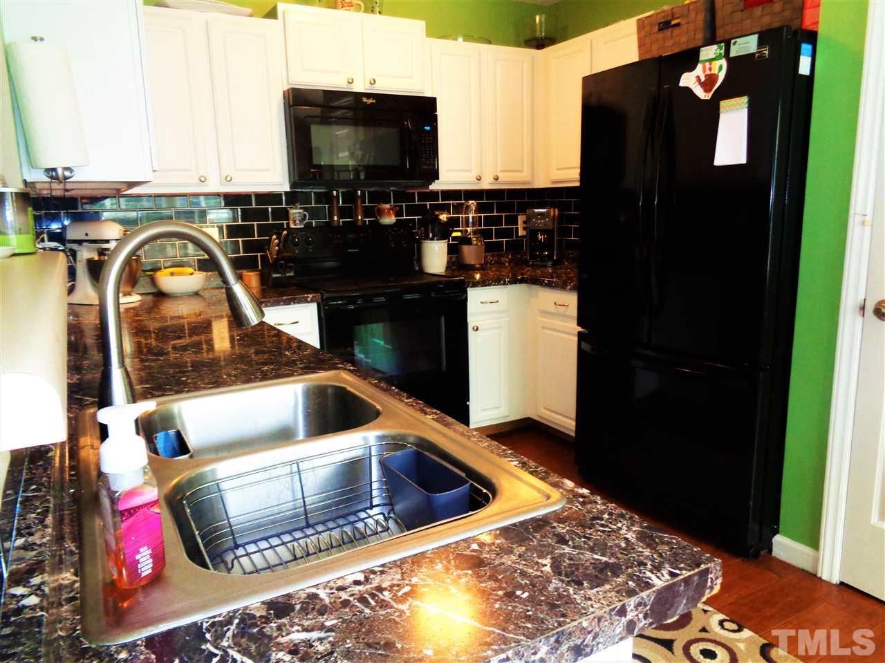 5304 Graymar Court Raleigh, NC 27616 - Photo 9 of 25 a kitchen with a refrigerator and a sink