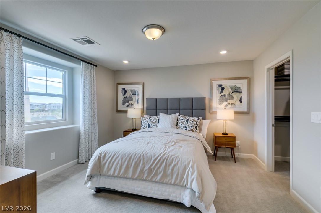 653 Pickled Pepper Place Henderson, NV 89011 - Photo 25 of 35 Well-lit sleeping quarters with plush carpeting and modern recessed lighting.