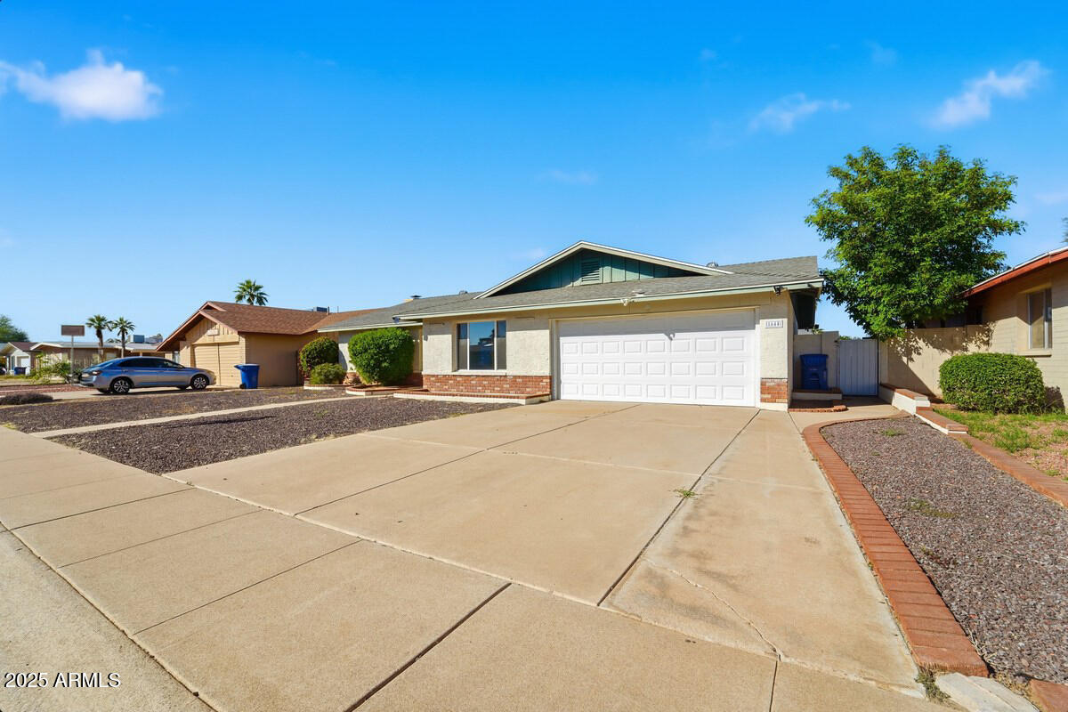1644 East Broadmor Drive Tempe, AZ 85282 - Photo 1 of 49 a front view of a house with a yard and garage
