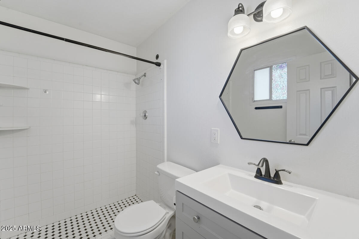 1644 East Broadmor Drive Tempe, AZ 85282 - Photo 14 of 49 a bathroom with a sink a toilet and shower