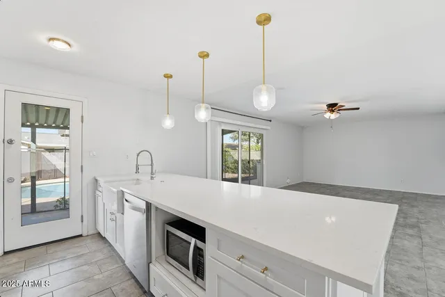 a view of a kitchen with electric appliances