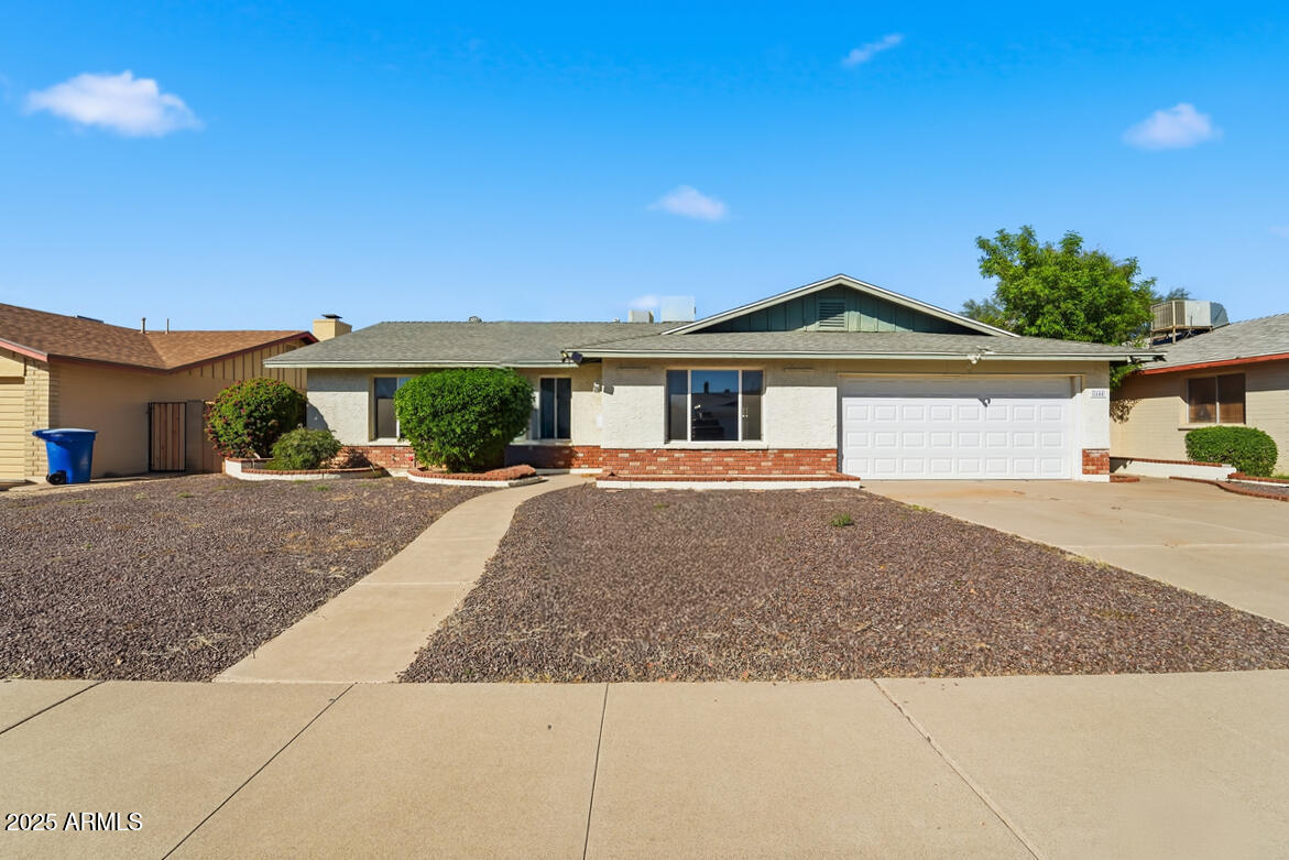 1644 East Broadmor Drive Tempe, AZ 85282 - Photo 3 of 49 a front view of a house with a yard and potted plants