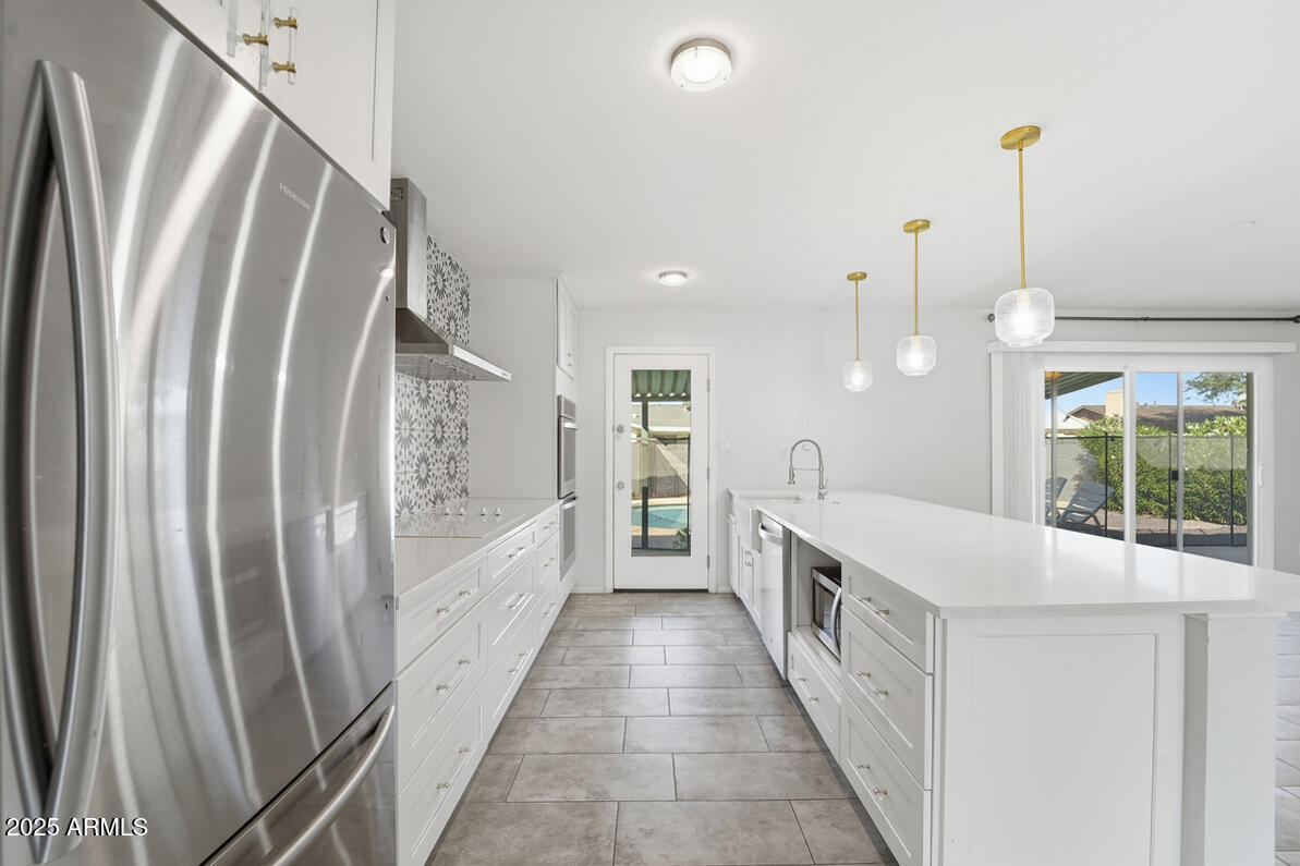 1644 East Broadmor Drive Tempe, AZ 85282 - Photo 36 of 49 a view of a kitchen with fridge and wooden floor