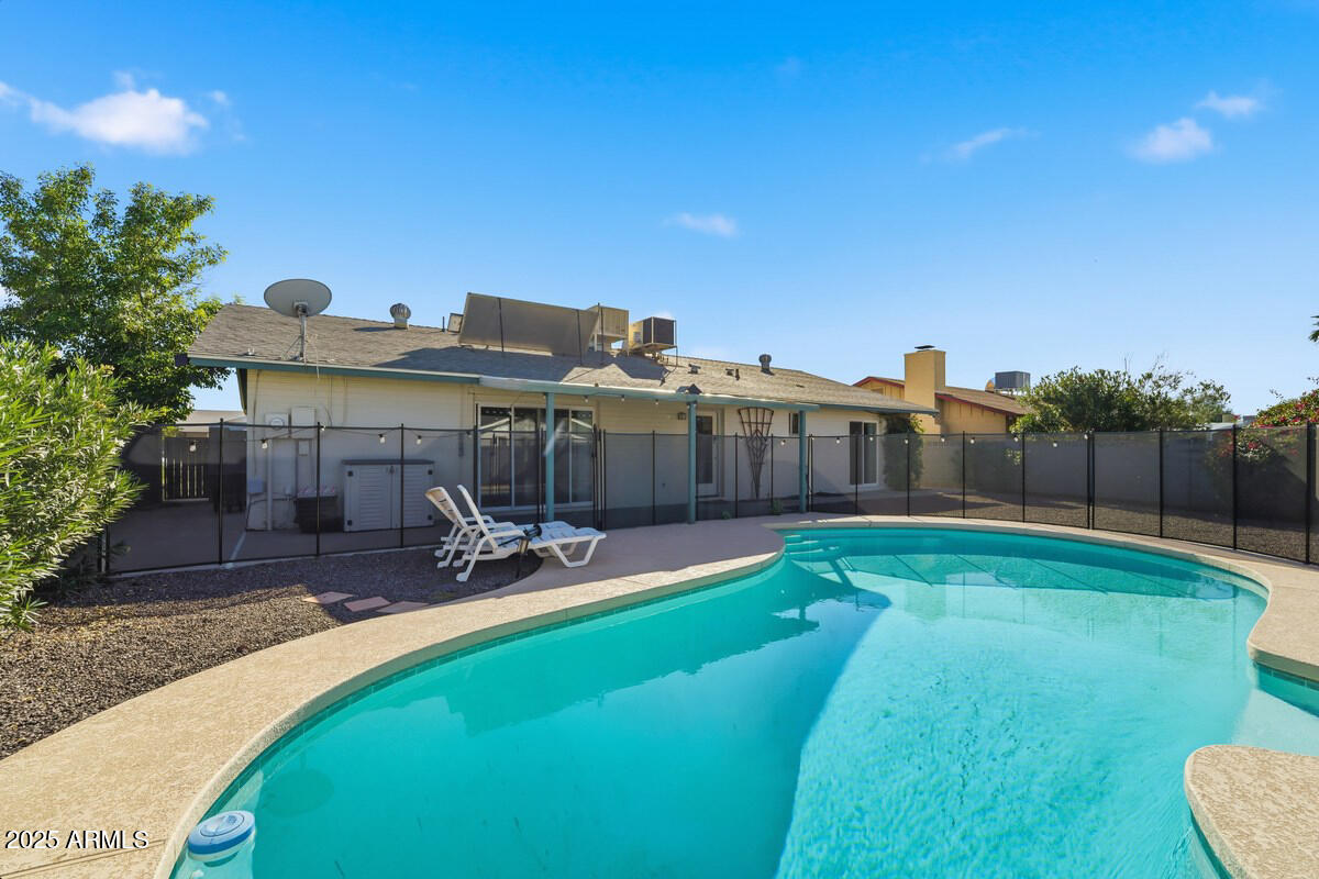 1644 East Broadmor Drive Tempe, AZ 85282 - Photo 42 of 49 a view of a swimming pool with a patio and a yard