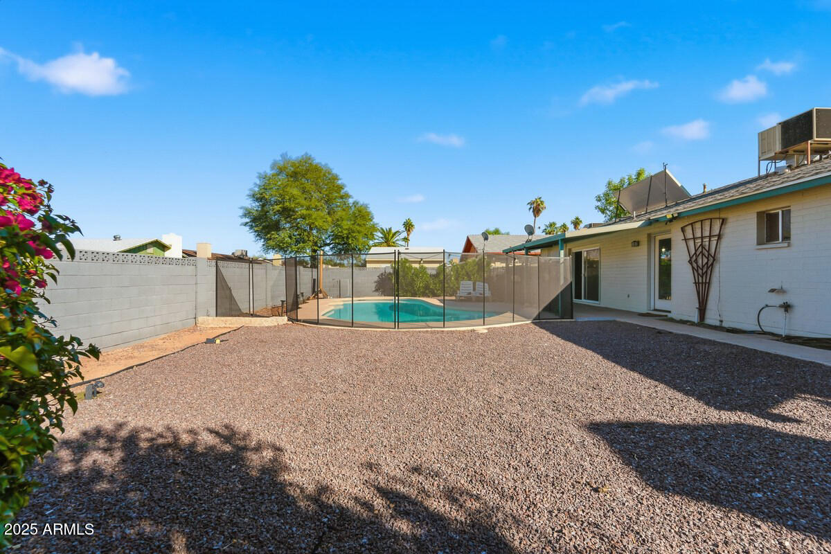 1644 East Broadmor Drive Tempe, AZ 85282 - Photo 43 of 49 a house with a yard and a wooden fence