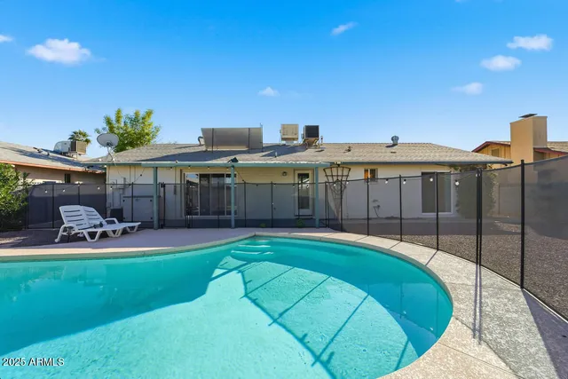 a view of a backyard with swimming pool