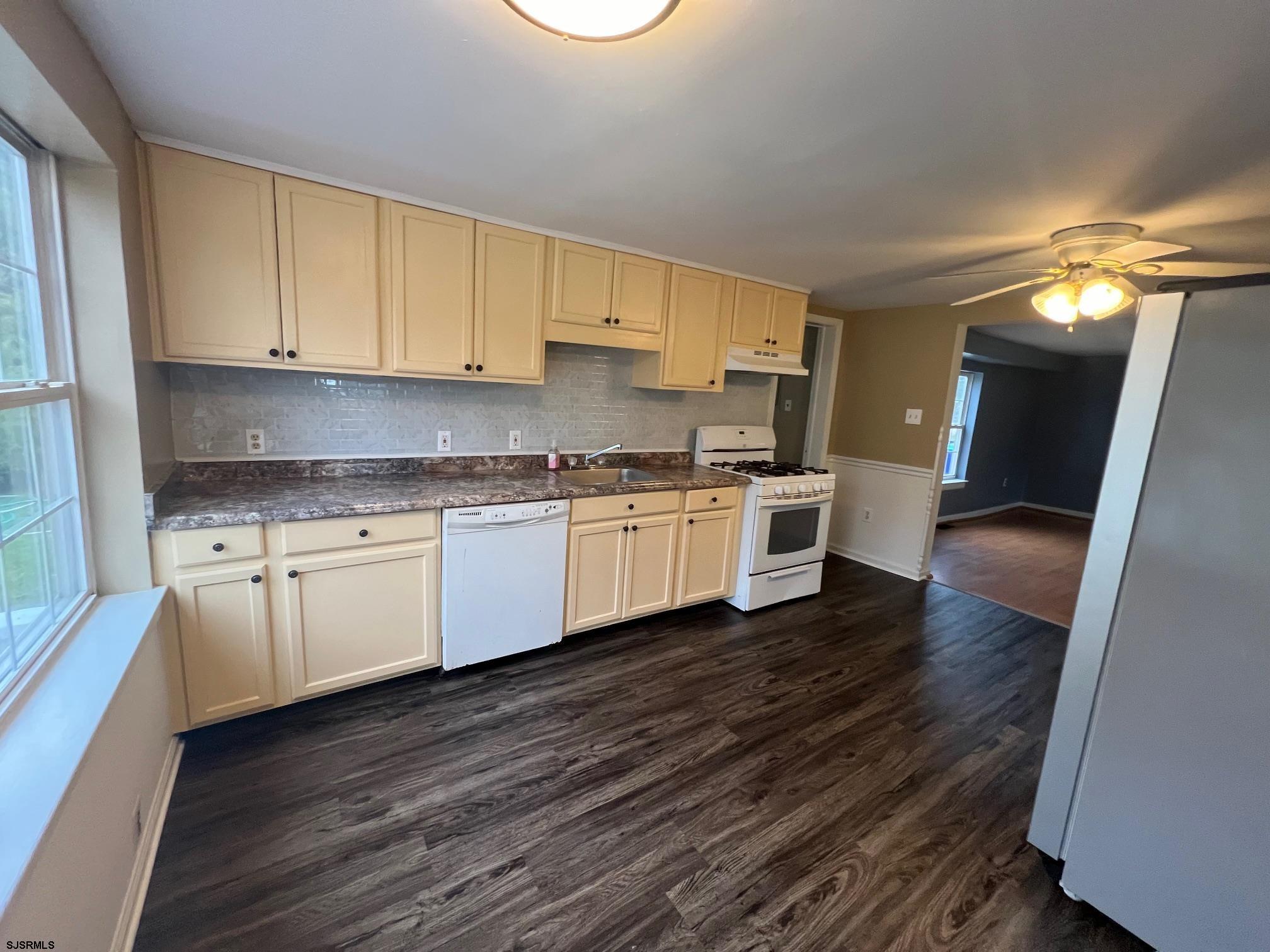 219 Pleasant Mills Road Hammonton, NJ 08037 - Photo 8 of 14 a kitchen with wooden floors and white stainless steel appliances