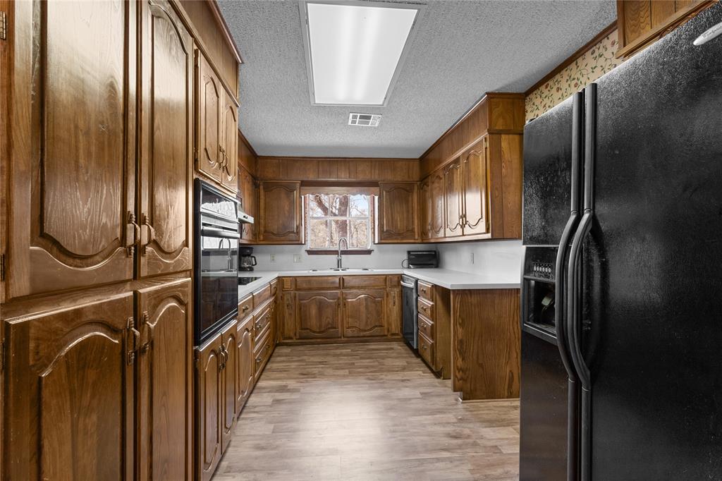 1447 Red Gate Road Mart, TX 76664 - Photo 30 of 38 a kitchen with stainless steel appliances granite countertop a refrigerator a stove and a sink