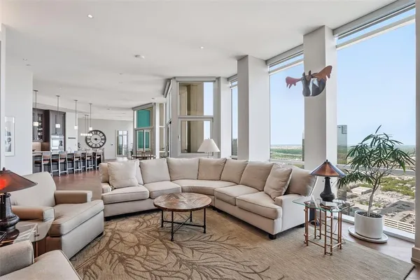a living room with furniture fireplace and a large window