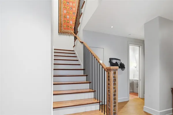 a kitchen with stainless steel appliances granite countertop a sink a stove and a wooden floors