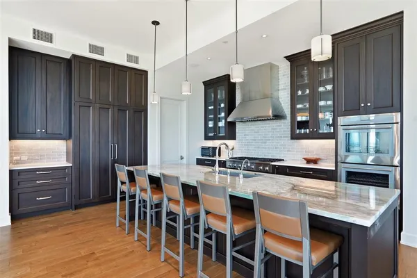 a dining room with furniture a chandelier and wooden floor