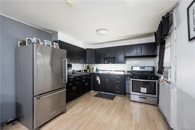 a kitchen with stainless steel appliances a refrigerator a stove a sink a microwave and cabinets