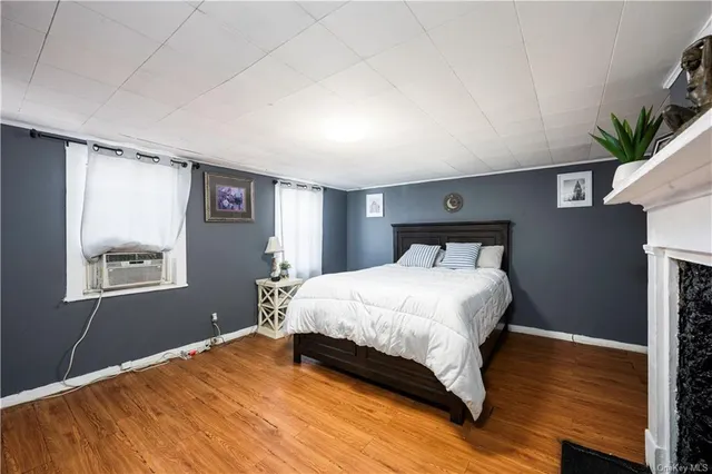 a bedroom with a bed and a potted plant
