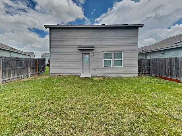 a view of a house with a backyard