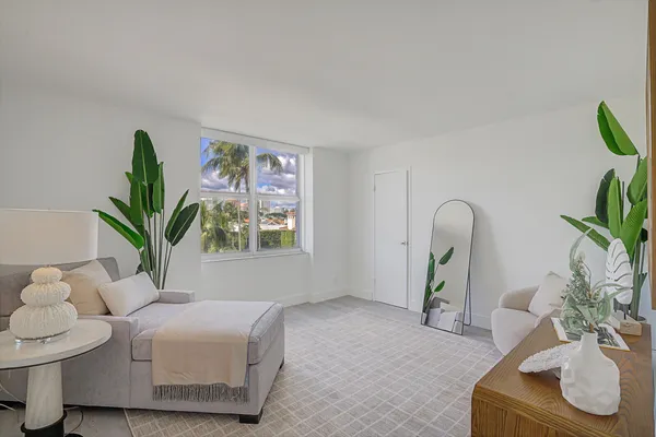 a living room with furniture flowerpot and window