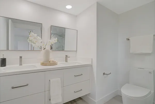 a bathroom with a toilet sink and mirror