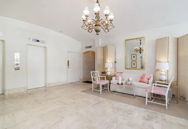 a living room with furniture and a chandelier
