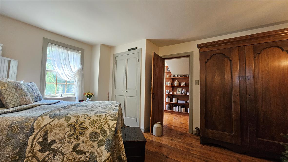 585 Buttermilk Road Hellertown, PA 18055 - Photo 31 of 82 Authentic wood flooring grounds this well-lit bedroom, offering both comfort and enduring style.