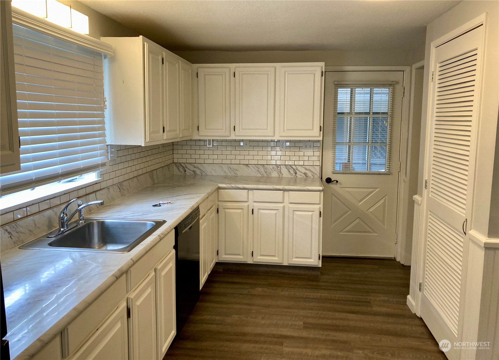 522 Centre Street La Conner, WA 98257 - Photo 12 of 30 a kitchen with cabinets appliances a sink and a window