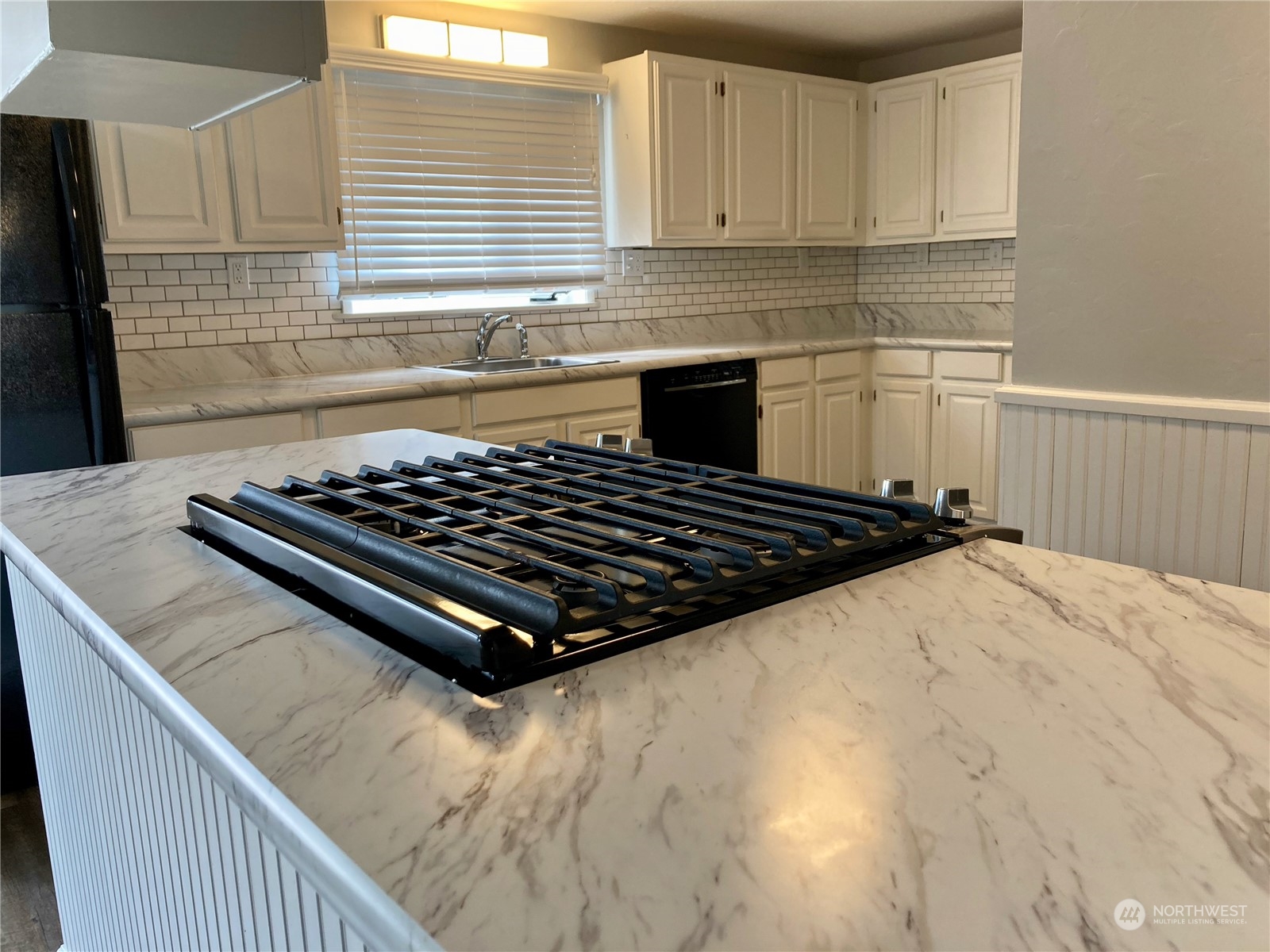 522 Centre Street La Conner, WA 98257 - Photo 14 of 30 a kitchen with a stove a sink and cabinets