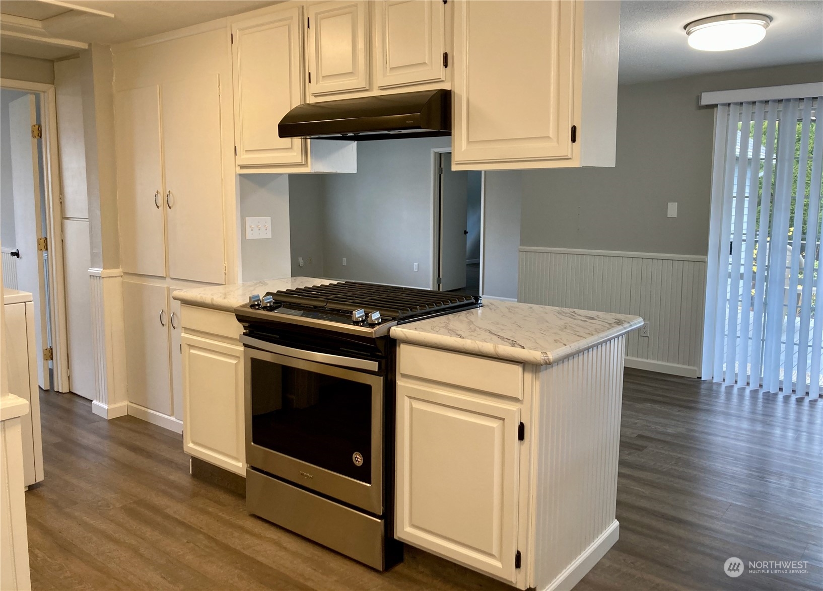 522 Centre Street La Conner, WA 98257 - Photo 15 of 30 a kitchen with granite countertop a stove and a wooden floors
