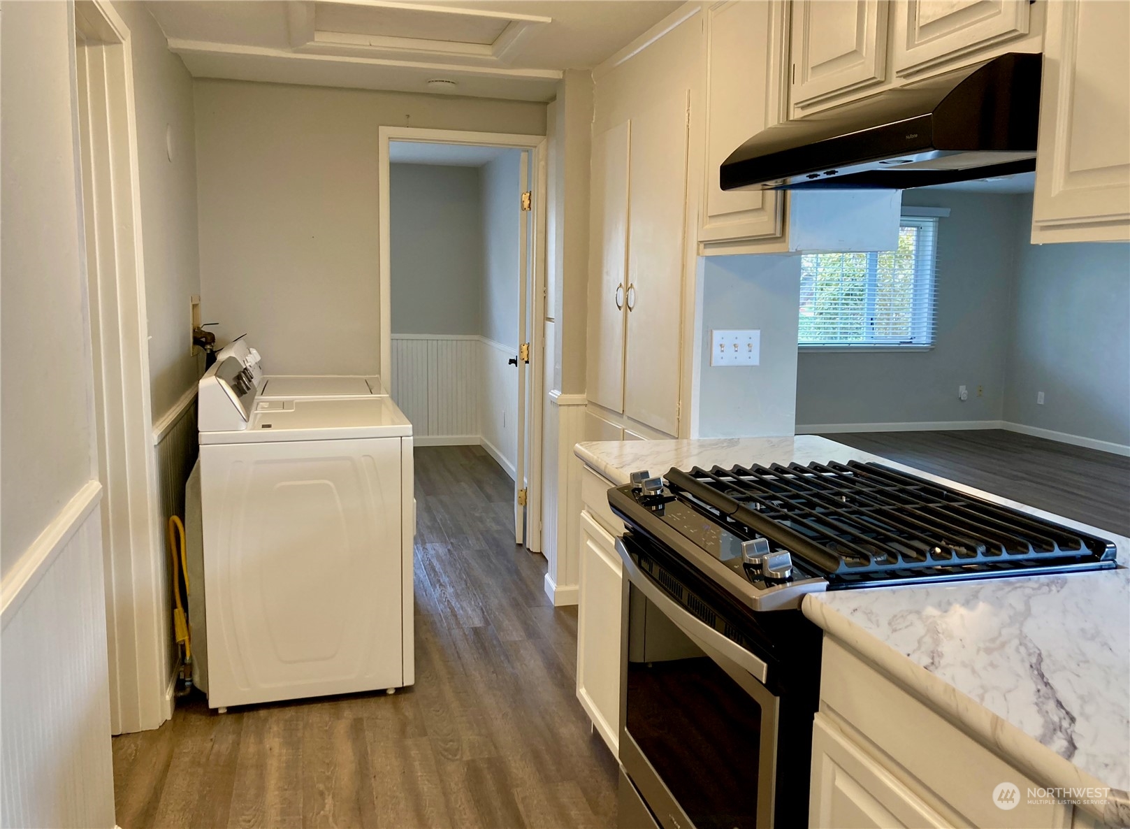 522 Centre Street La Conner, WA 98257 - Photo 16 of 30 a kitchen with granite countertop a sink stove and cabinets