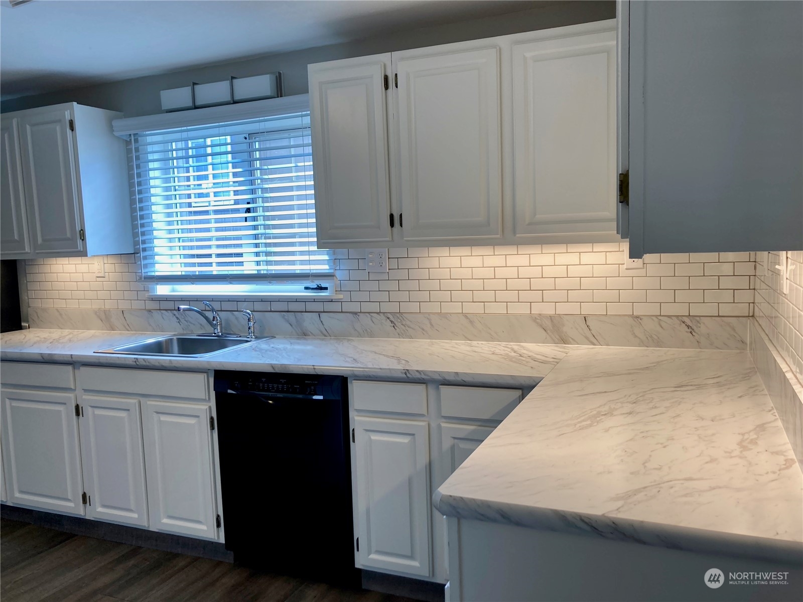 522 Centre Street La Conner, WA 98257 - Photo 17 of 30 a kitchen with granite countertop a sink and a white cabinets