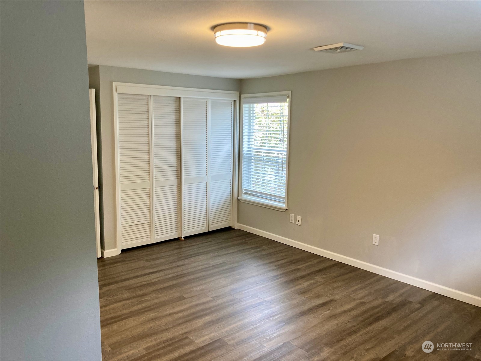 522 Centre Street La Conner, WA 98257 - Photo 7 of 30 an empty room with wooden floor and windows