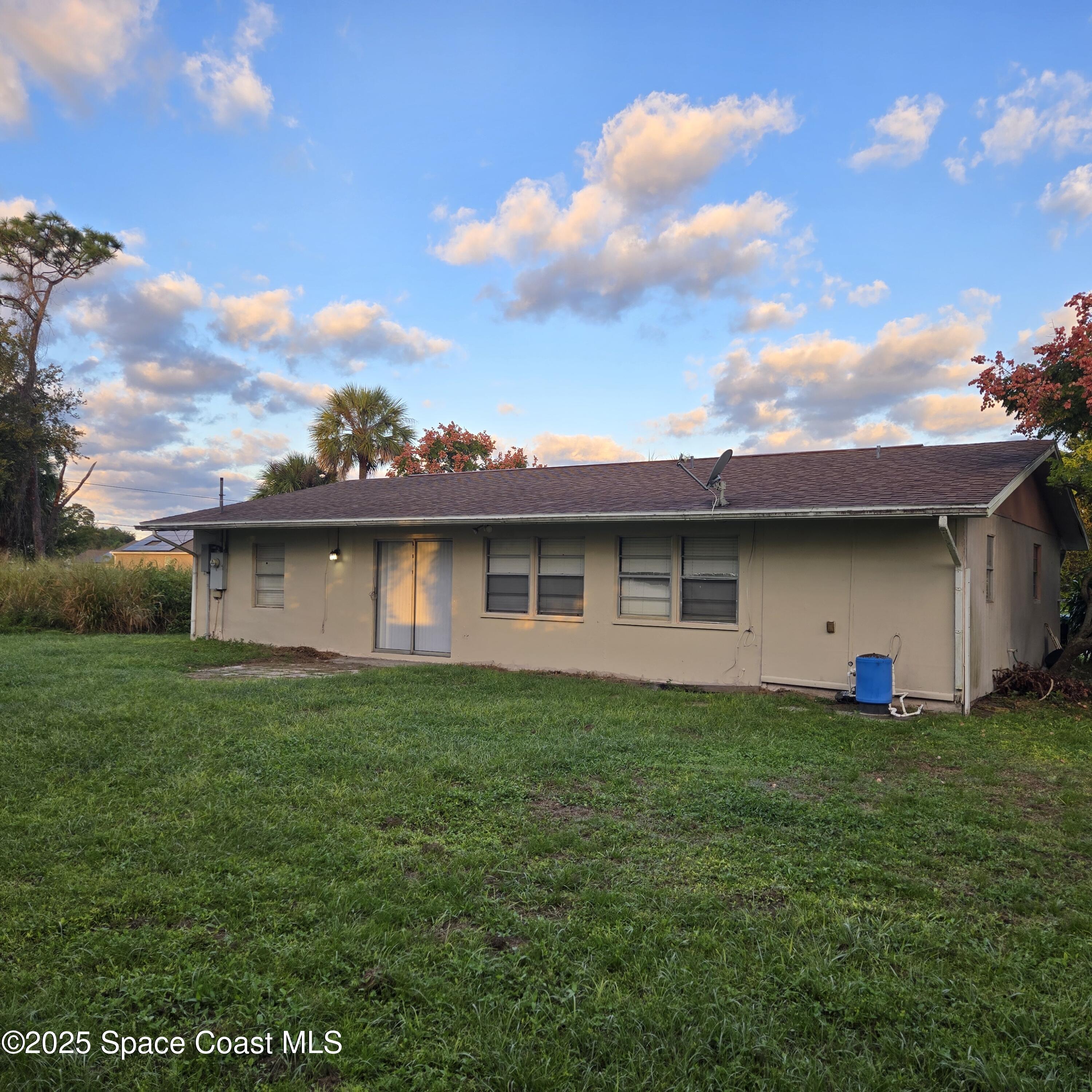 349 El Rancho Terrace Northeast Palm Bay, FL 32907 - Photo 2 of 9 a front view of a house with a garden
