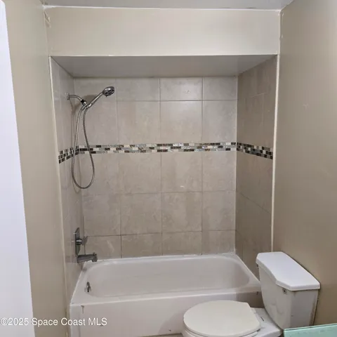 a bathroom with a shower and a toilet
