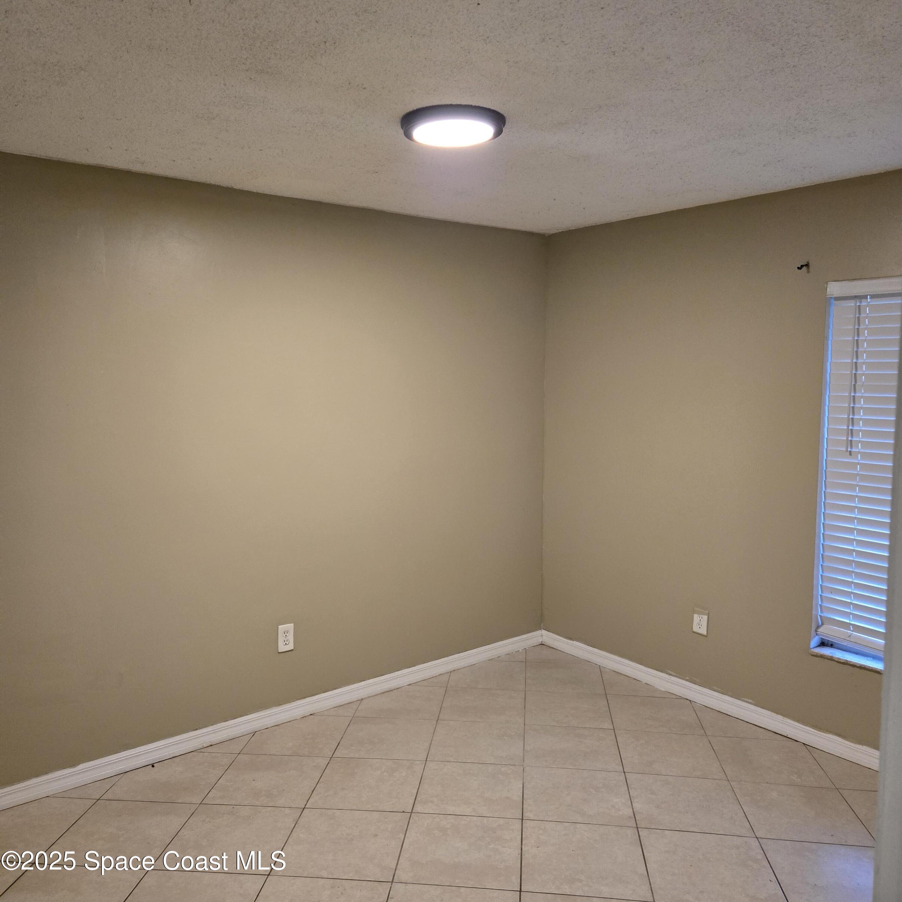 349 El Rancho Terrace Northeast Palm Bay, FL 32907 - Photo 4 of 9 a view of an empty room with a window