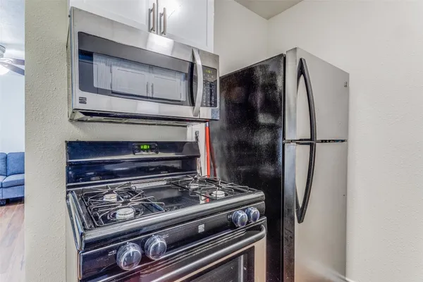 a stove top oven sitting inside of a kitchen