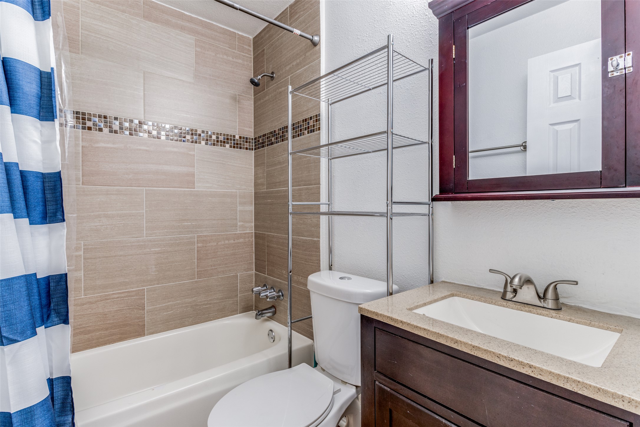 2401 Manor Road, Unit 113 Austin, TX 78722 - Photo 8 of 12 Bathroom featuring shower / tub combo, toilet, and vanity