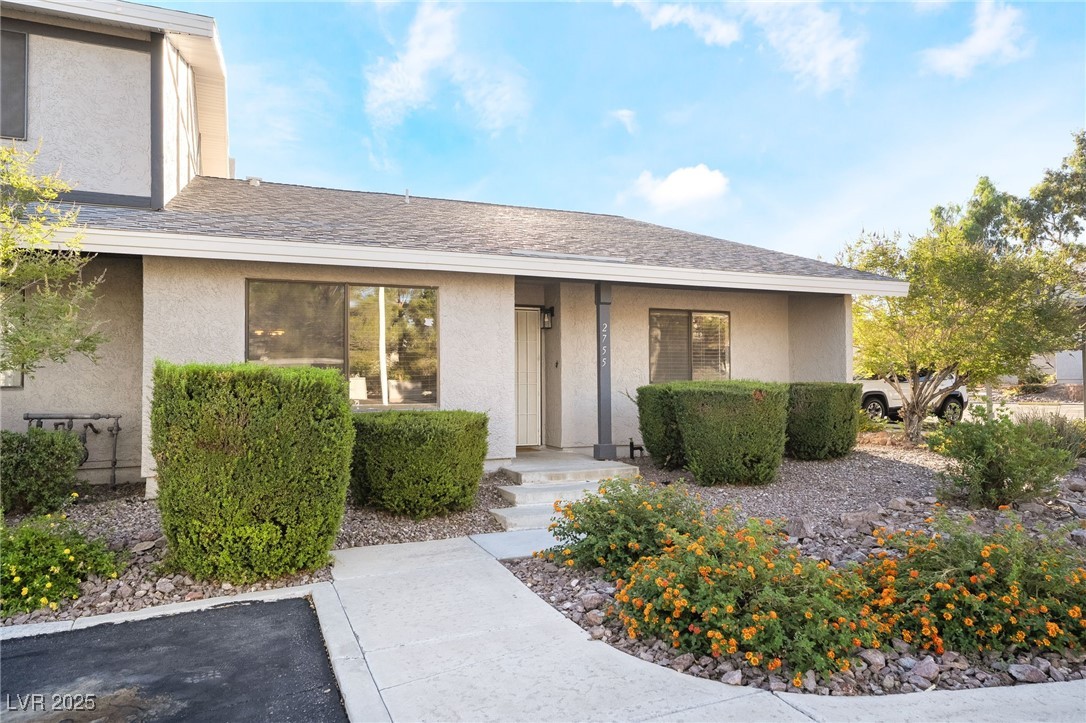 2755 Carnation Lane Henderson, NV 89074 - Photo 2 of 42 Doorway to property with stucco siding and a shingled roof