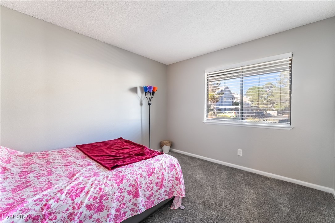 2755 Carnation Lane Henderson, NV 89074 - Photo 26 of 42 Bedroom with carpet and a textured ceiling