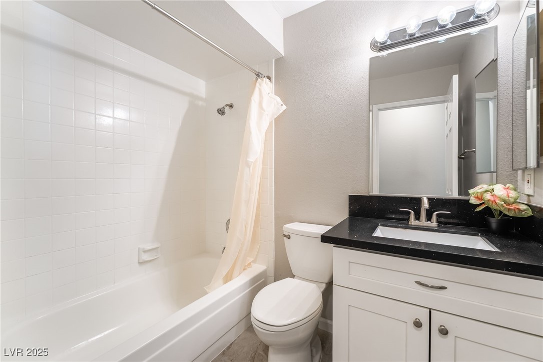 2755 Carnation Lane Henderson, NV 89074 - Photo 29 of 42 Bathroom featuring shower / bath combo, vanity, and a textured wall