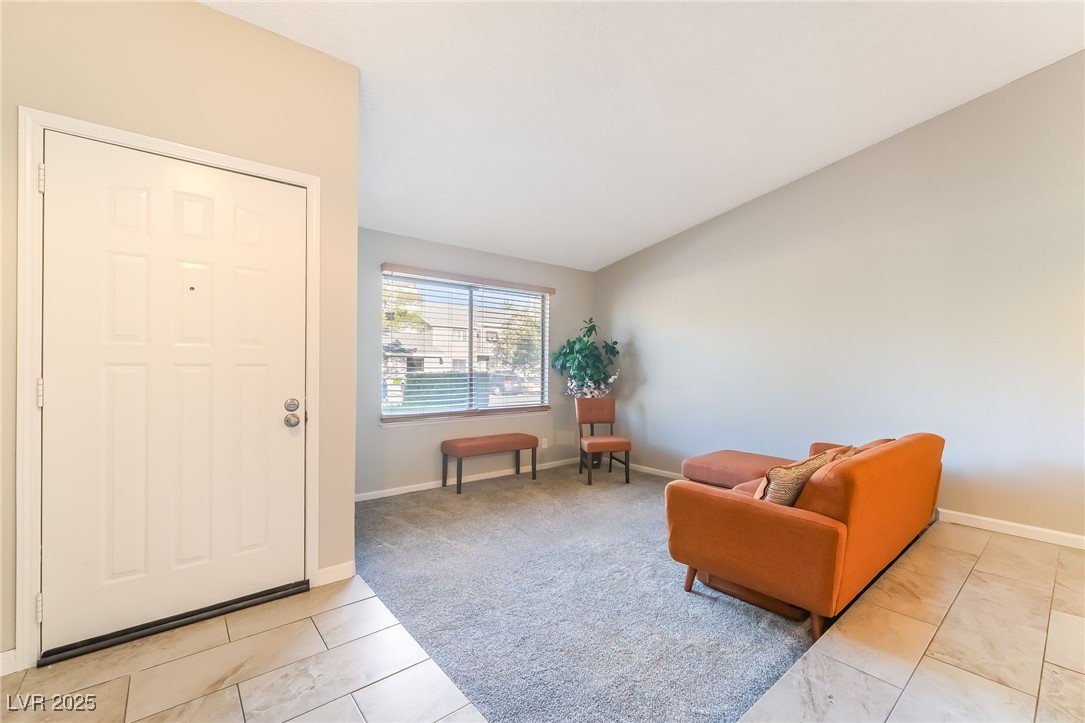 2755 Carnation Lane Henderson, NV 89074 - Photo 3 of 42 Entryway featuring light tile patterned floors and vaulted ceiling
