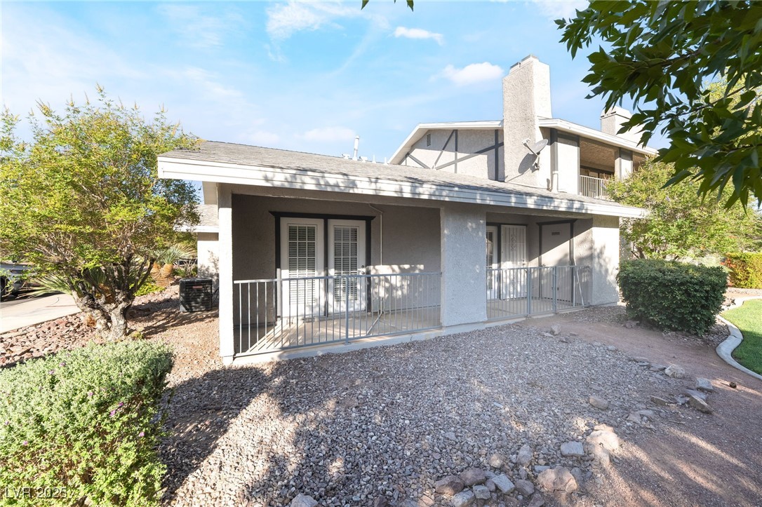 2755 Carnation Lane Henderson, NV 89074 - Photo 36 of 42 Back of property featuring a chimney and stucco siding
