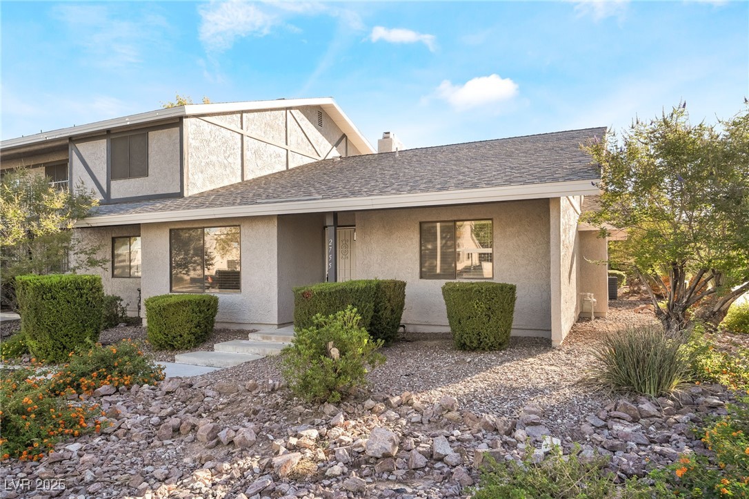 2755 Carnation Lane Henderson, NV 89074 - Photo 42 of 42 View of front facade featuring a shingled roof, stucco siding, and a chimney