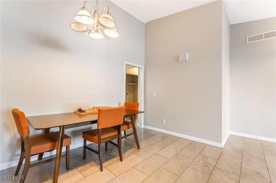 2755 Carnation Lane Henderson, NV 89074 - Photo 8 of 42 Dining room with a high ceiling and a chandelier