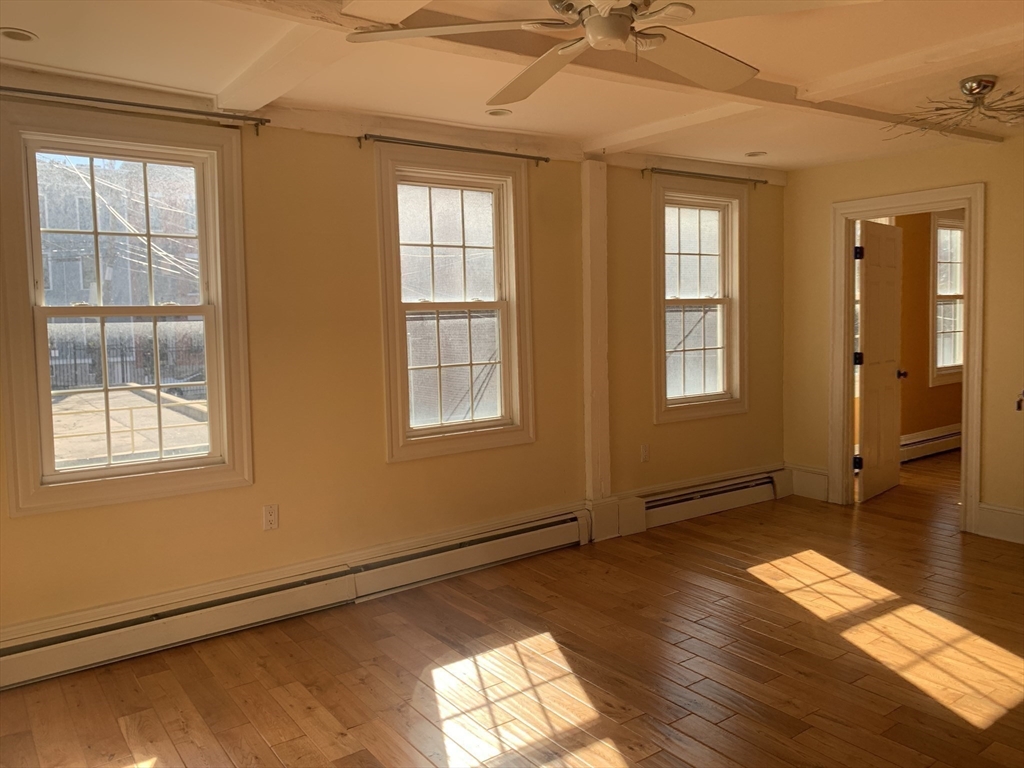 10 Salem St Avenue, Unit 2 Boston, MA 02129 - Photo 11 of 32 an empty room with wooden floor and windows