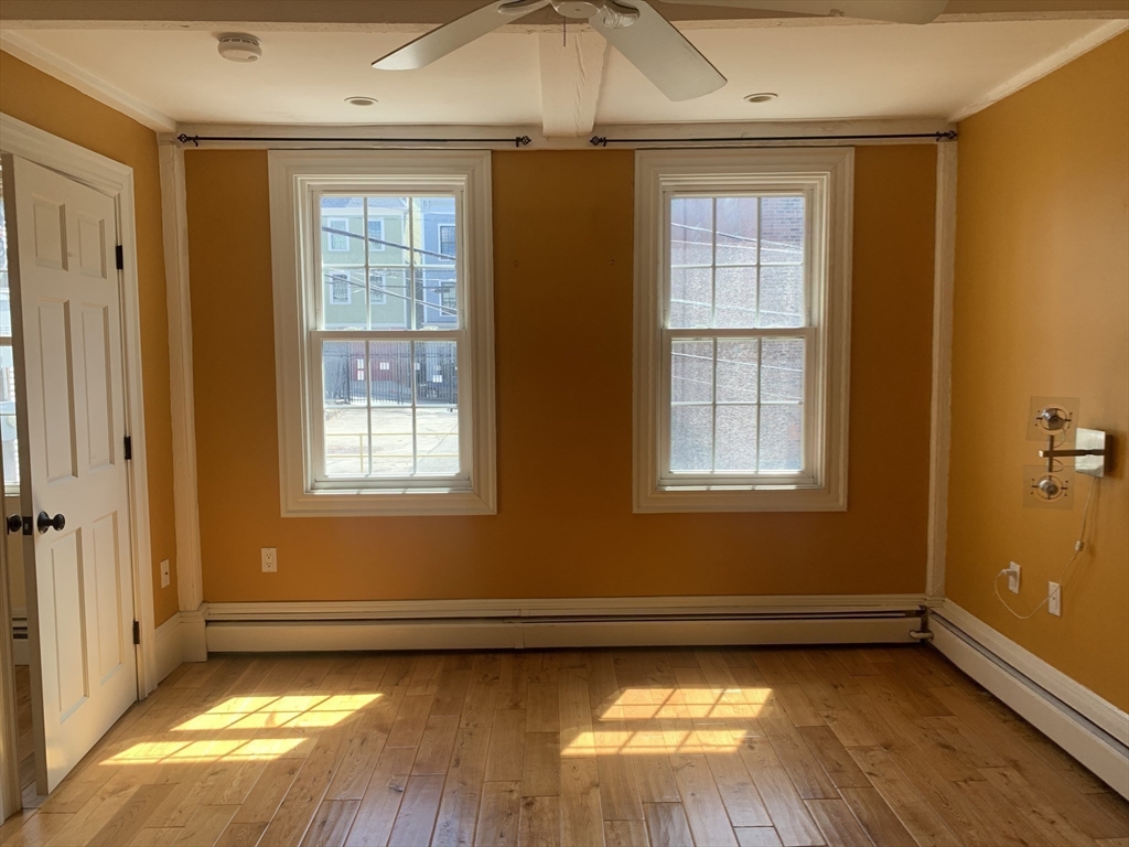 10 Salem St Avenue, Unit 2 Boston, MA 02129 - Photo 17 of 32 a view of a livingroom with wooden floor and a window