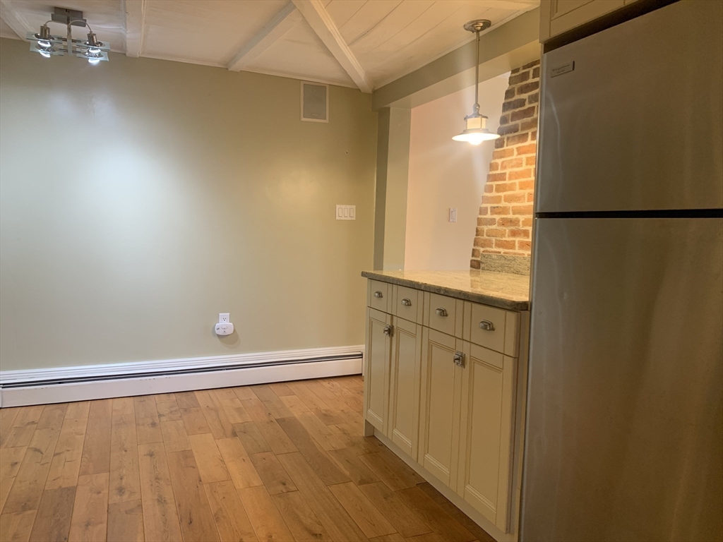 10 Salem St Avenue, Unit 2 Boston, MA 02129 - Photo 6 of 32 a view of an empty room with wooden floor and a window