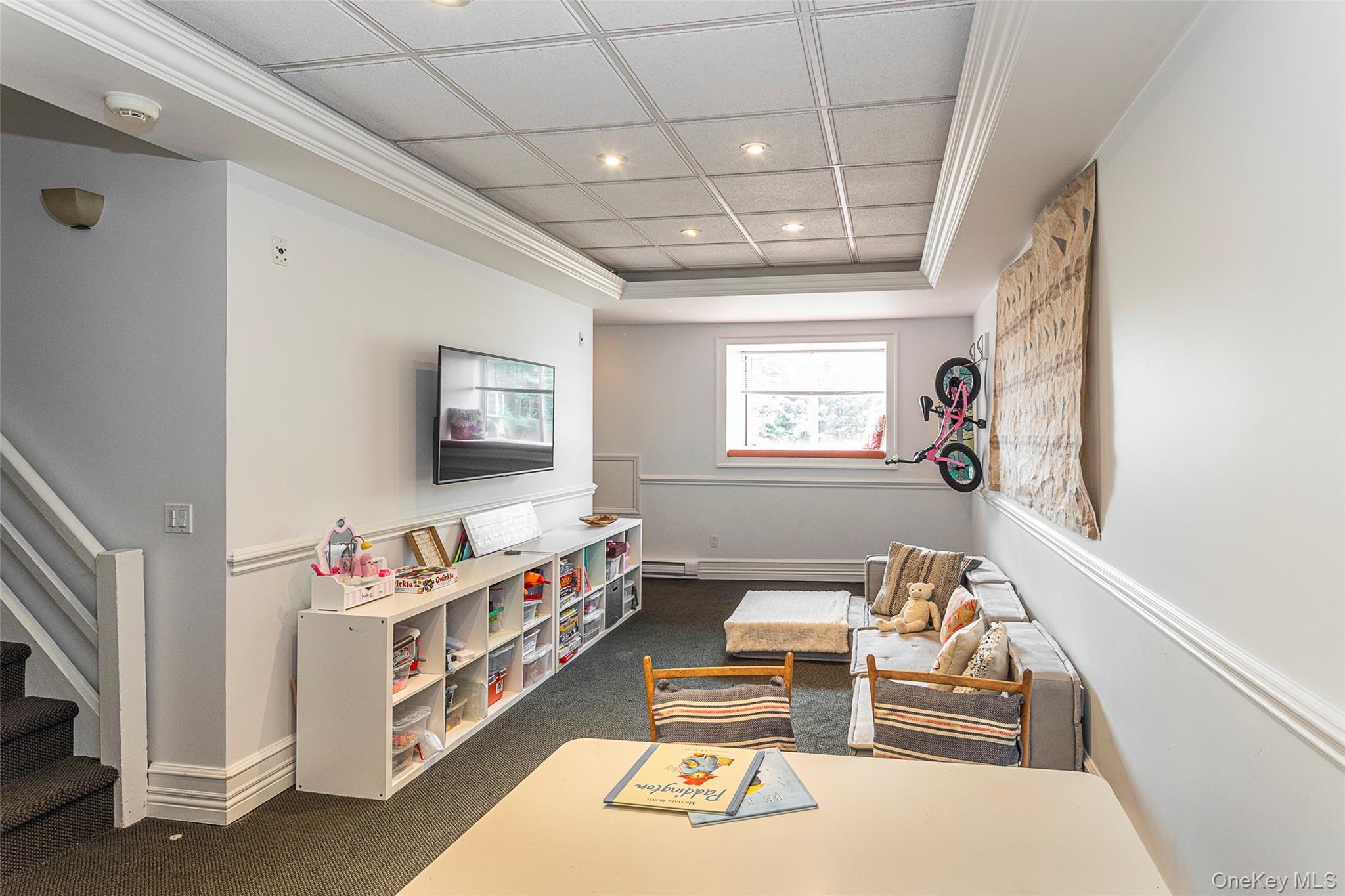 41 Sagamore Road Bronxville, NY 10708 - Photo 27 of 38 Lower level rec room featuring ornamental molding, recessed lighting, a tray ceiling, carpet floors and back door to parking