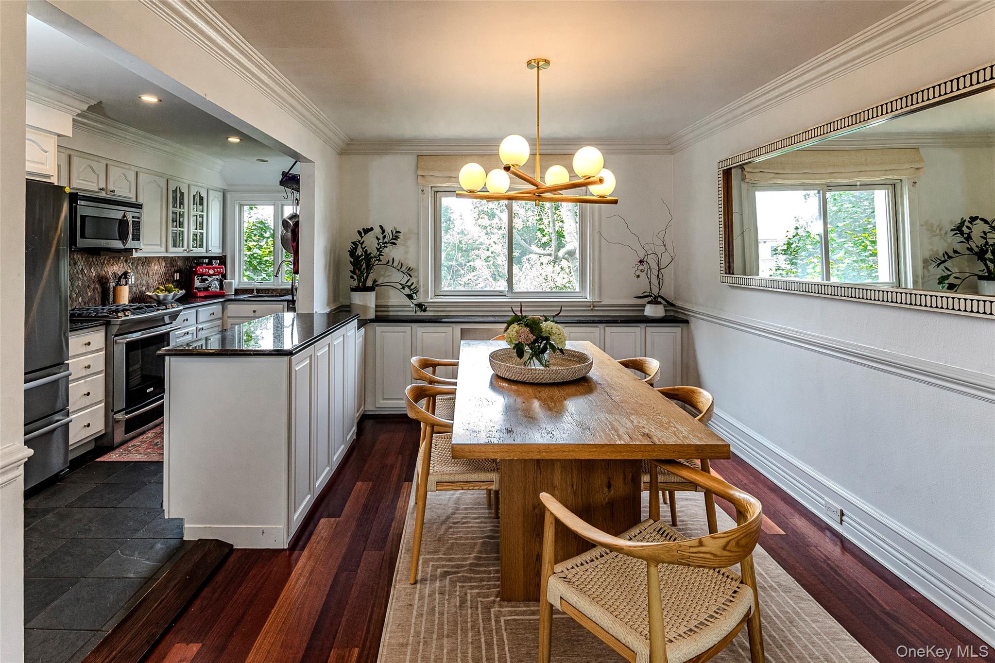 41 Sagamore Road Bronxville, NY 10708 - Photo 9 of 38 Dining area featuring ornamental molding, natural light, hardwood floors, and a chandelier