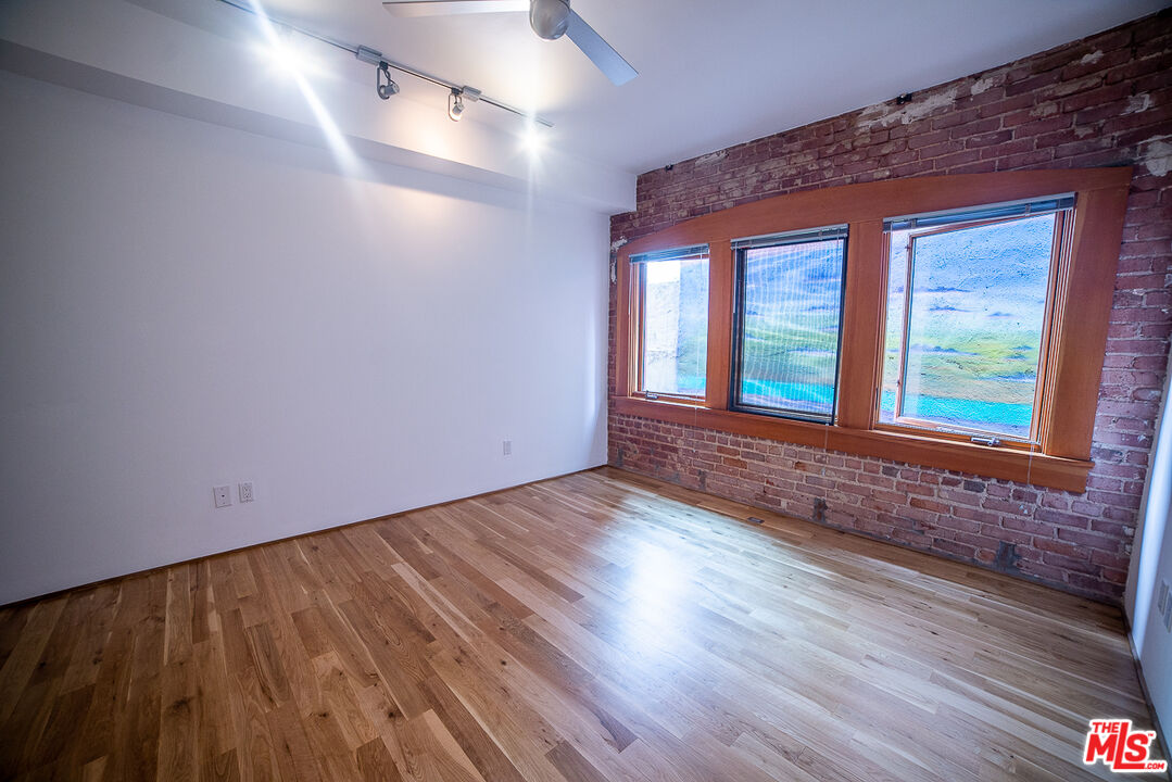 8 Brooks Avenue, Unit 10 Venice, CA 90291 - Photo 15 of 15 a view of an empty room with wooden floor and a window