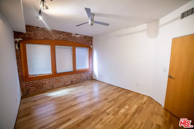 a view of an empty room and wooden floor